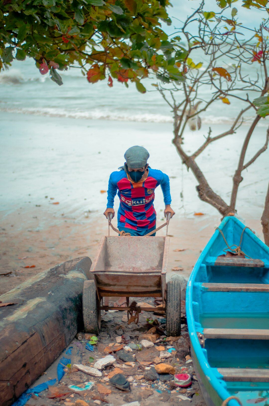 old man cleaning beach