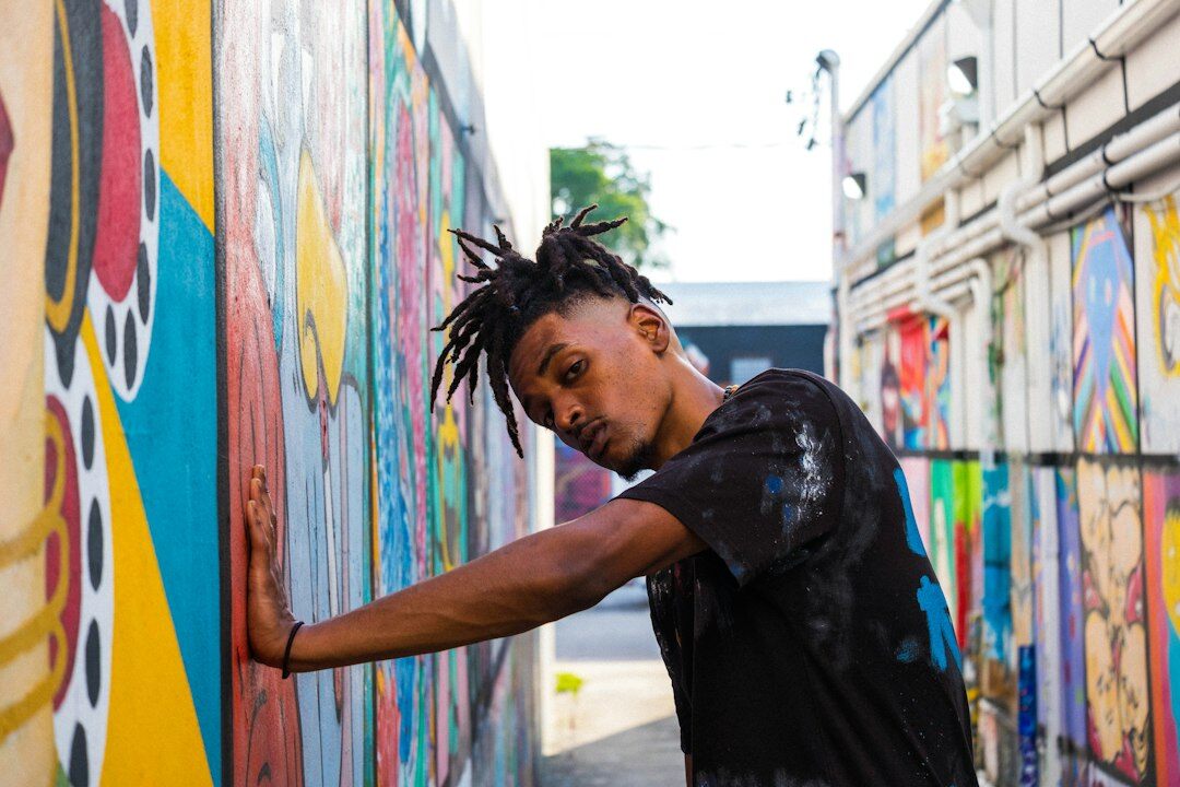 young artist painting wall